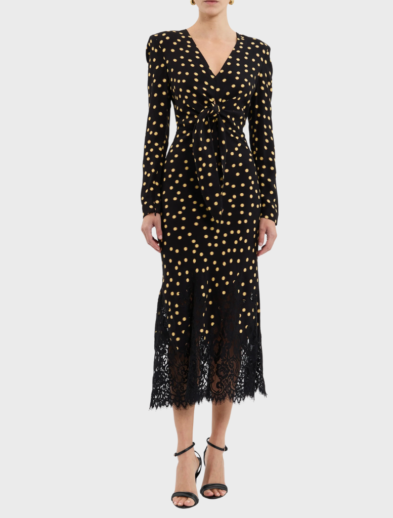  A stylish black and gold polka dot dress featuring delicate lace trim.