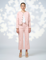  The model is dressed in a coordinated outfit featuring a pink jacket and pants.