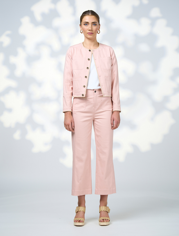  The model is dressed in a coordinated outfit featuring a pink jacket and pants.