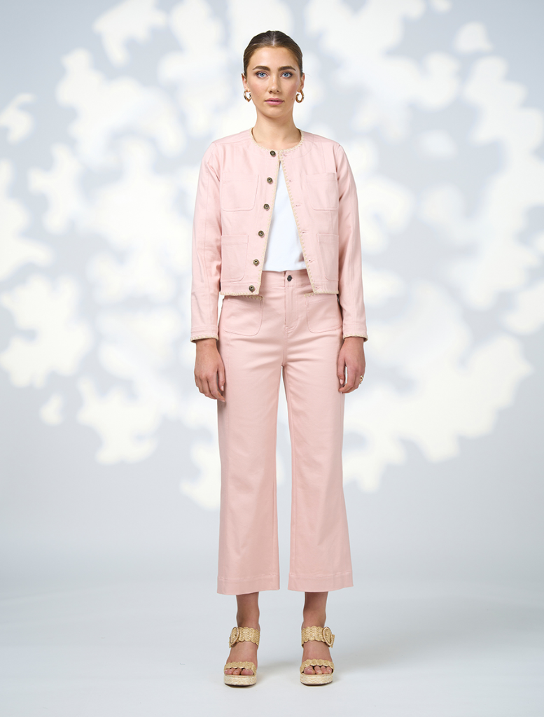  The model is dressed in a coordinated outfit featuring a pink jacket and pants.