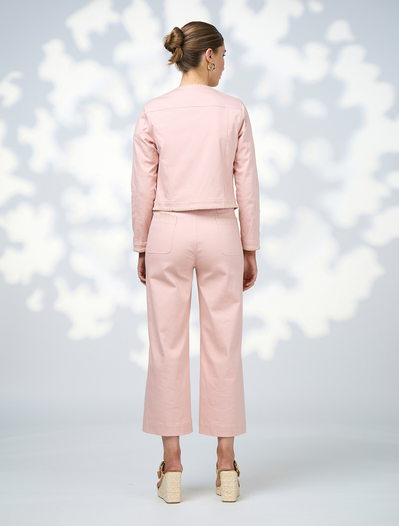 A model showcases a stylish pink jacket paired with matching pink pants.