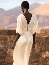 Sophisticated ecru dress with flowing design, V-neck, black bias binding, and adjustable tie for a comfortable fit.