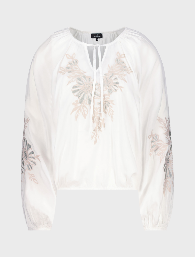 White blouse featuring colorful embroidered flowers on the front, showcasing a delicate and stylish design.