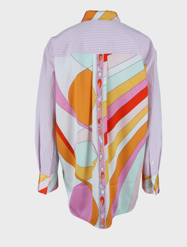  A blouse named " Gigi Multi" featuring vibrant, colorful patterns throughout the fabric.