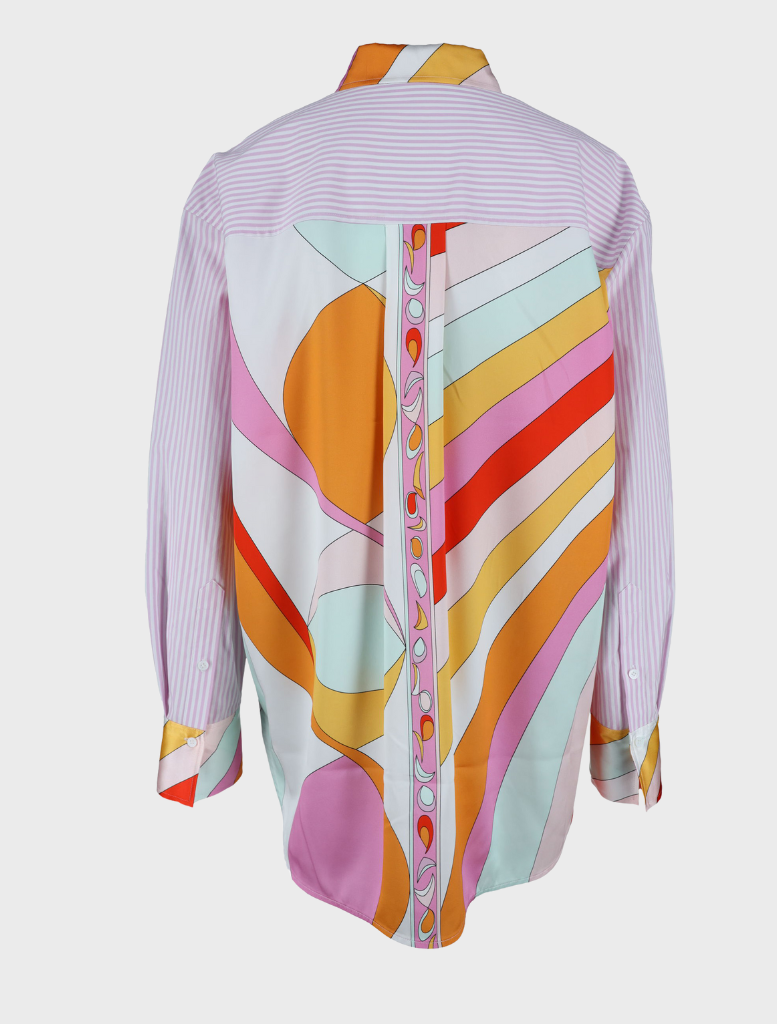 A blouse named " Gigi Multi" featuring vibrant, colorful patterns throughout the fabric.