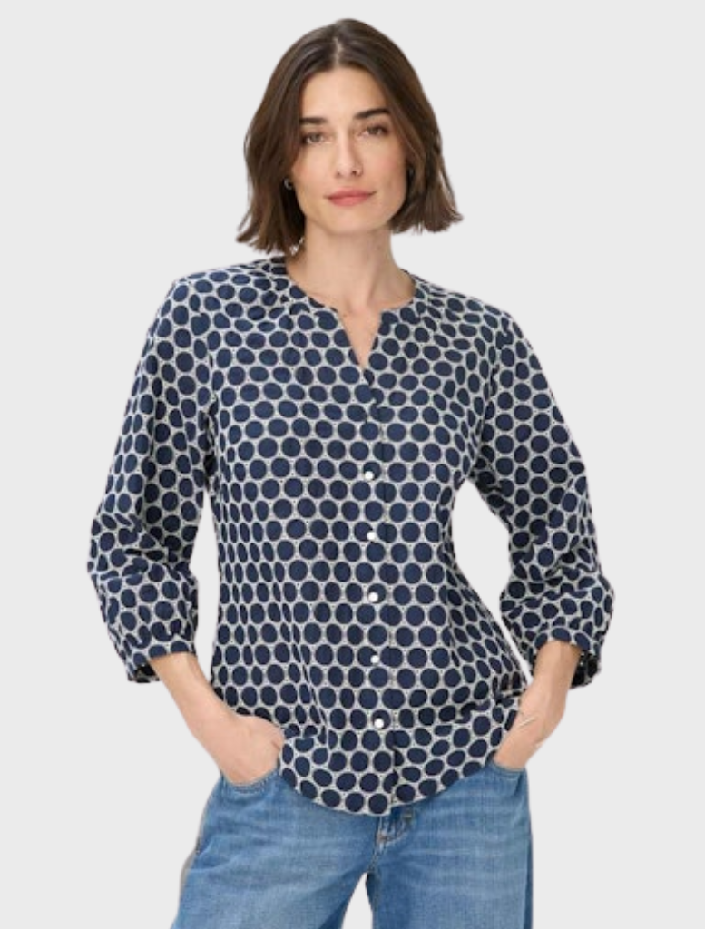 Navy and white polka dot blouse, stylish and versatile for various occasions.