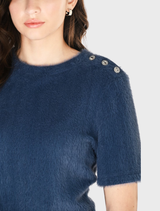 The image features a model in a blue denim shirt and a skirt, presenting a trendy outfit suitable for various occasions.