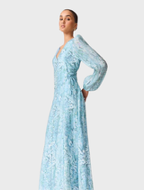 Faye Maxi Dress in blue multi, showcasing a long silhouette and long sleeves adorned with floral patterns.