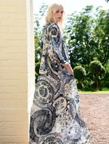 Blue dress with playful cut-out sleeves, adjustable drawstrings, and a relaxed drop shoulder for an easy, elegant fit.