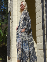 Modern blue dress with cut-out sleeves, adjustable drawstrings, and a V-neckline, crafted from viscose georgette.