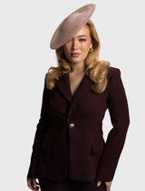 Timeless blush pink fascinator with a circular base and sheer accents, crafted for effortless styling at formal events.