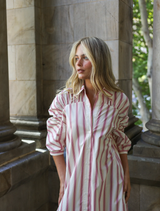 Blythe Dress features a collared neckline, button-front, gathered sleeves, and A-line shape, perfect for warm-weather occasions.