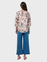 Stylish blouse featuring flared sleeves, shirred shoulders, and contrasting panels for an elegant look.