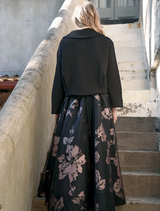 Elegant black skirt with pink accents and a bow, perfect for adding a chic touch to any outfit.