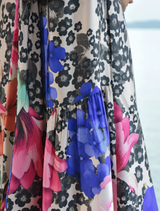 Feminine dress with a dip-back and tie detail, crafted in scattered daisies for a relaxed fit and soft movement.