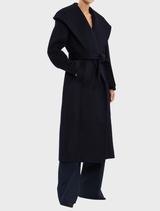 Navy Bower Coat presented on a hanger, highlighting its stylish design and tailored appearance for a polished outfit.