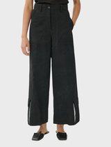 A pair of black Brams pants laid flat, highlighting the style and material details.