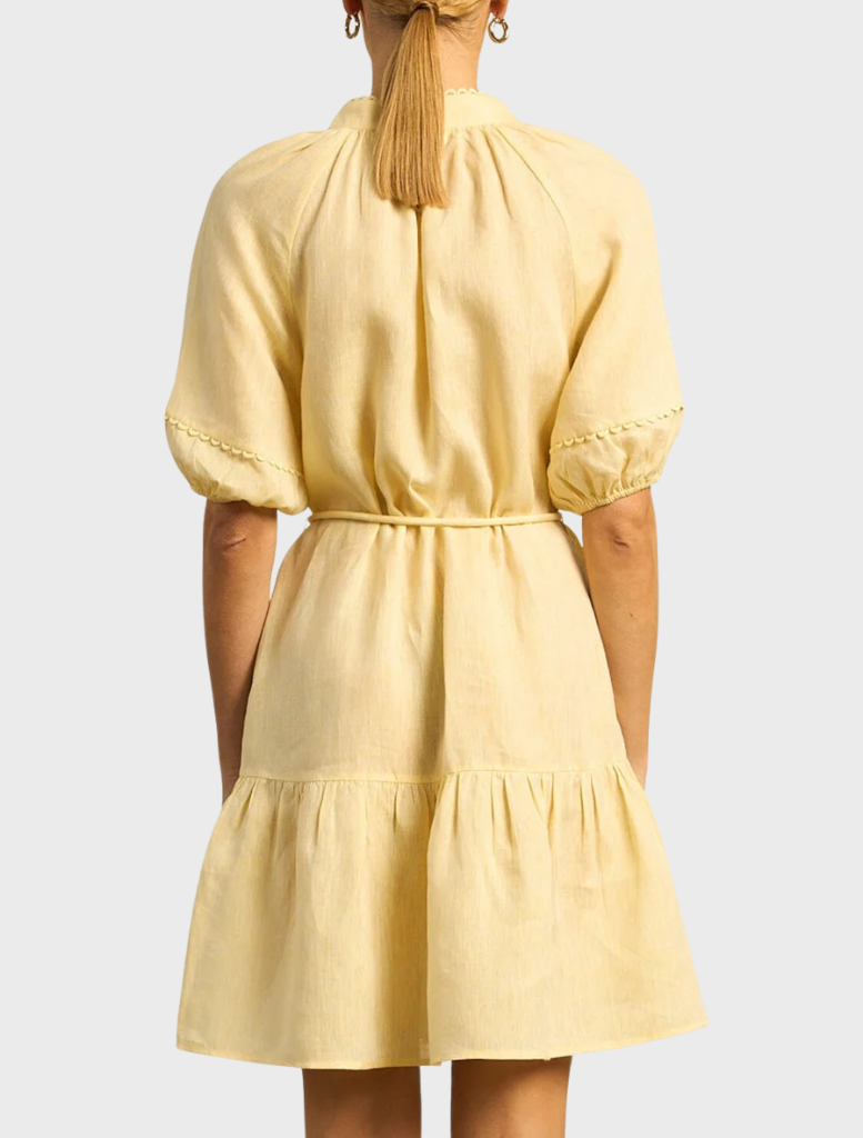 A vibrant solar dress in lemon yellow, featuring a playful lemonade design, perfect for sunny days and casual wear.
