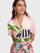 Brigitte Mini Dress showcasing a bright Riviera print, combining elegance and playfulness for summer occasions.