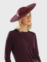 Stylish burgundy red racewear hat with a structured design and fitted headband, perfect for formal occasions and events.