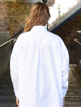 'C You Soon' white shirt featuring drop shoulders, full blouson sleeves, and a front pocket with 'Cooper' embroidery for versatility.