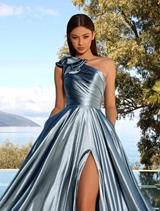 A cadet blue gown hanging on a rack, featuring a sleek silhouette and delicate details.