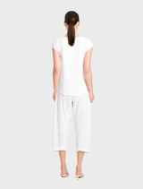 Charming café showcasing white walls and rustic furniture, designed for a comfortable and inviting dining experience.