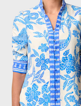 A woman dressed in a blue and white shirt featuring rouched sleeves, identified as the Calantha Viscose Dobby style.