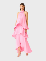 Flowing pink gown with shirred ruffle collar and tiered panels, offering timeless elegance for formal celebrations.