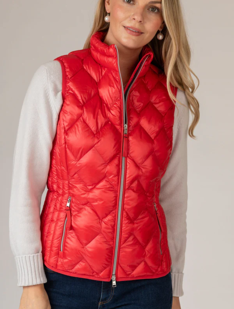 Women's red puffy vest crafted from breathable, lightweight fabric, suitable for stylish warmth in transitional seasons.
