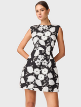 A black and white dress featuring floral designs that mimic the appearance of a blooming flower, highlighting its unique style.
