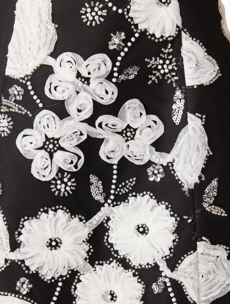 Black and white dress with floral patterns, ingeniously designed to resemble the shape and beauty of a flower.