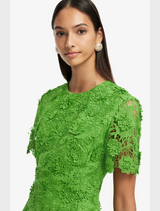  Elegant green dress made of lace, featuring short sleeves for a sophisticated touch.