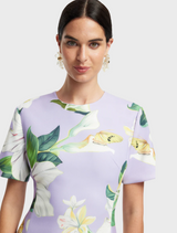 A dress showcasing a beautiful floral print, with an assortment of colorful flowers elegantly arranged across the fabric.