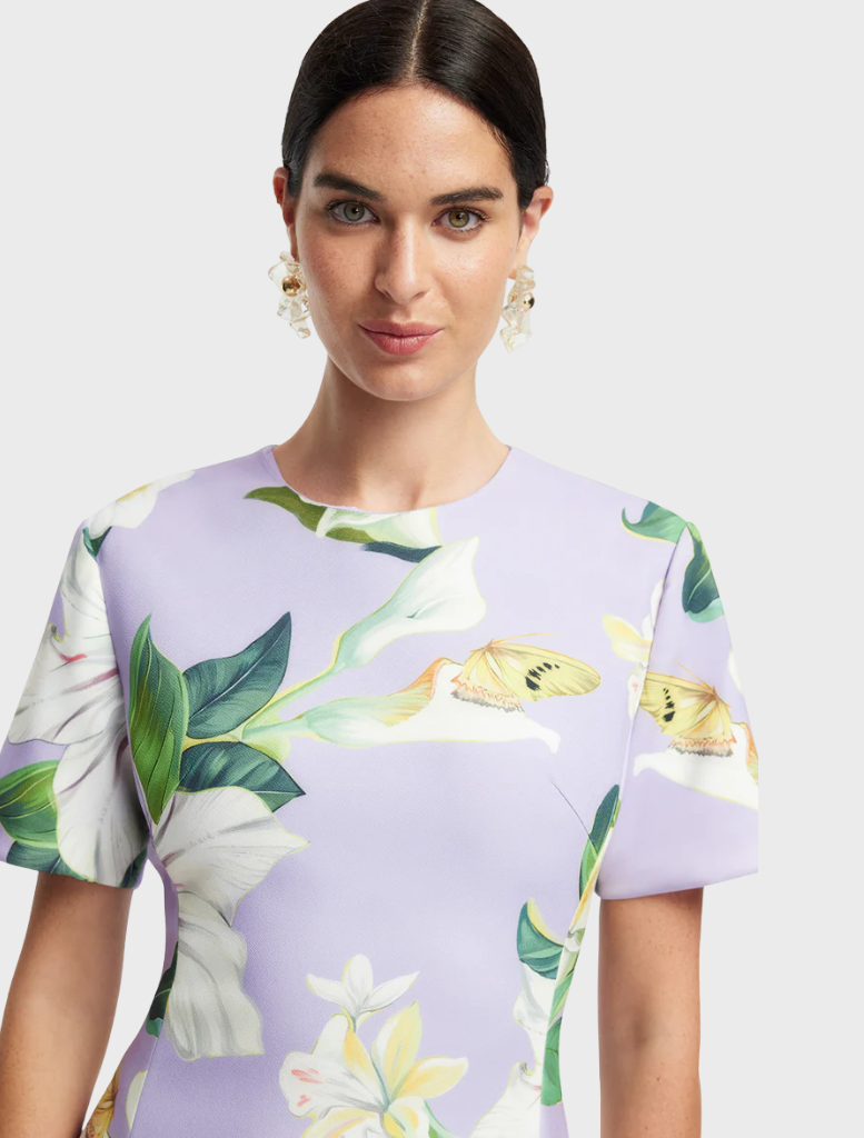 A dress showcasing a beautiful floral print, with an assortment of colorful flowers elegantly arranged across the fabric.