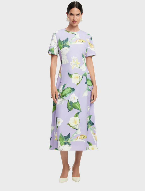 A floral print dress adorned with an array of colorful flowers, creating a lively and cheerful appearance.