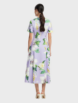 A dress made from a lively floral print, featuring colorful blooms that add a fresh and vibrant touch to the garment.