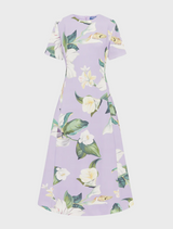  dress made from a lively floral print, featuring colorful blooms that add a fresh and vibrant touch to the garment.