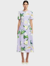 A dress featuring a vibrant floral print, showcasing a variety of colorful flowers against a light background.