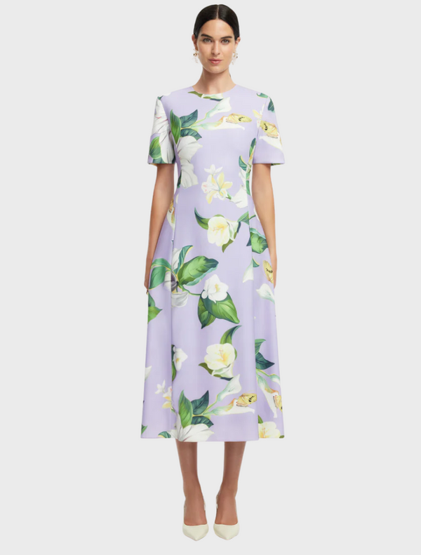 A dress featuring a vibrant floral print, showcasing a variety of colorful flowers against a light background.