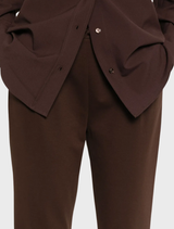 Stylish high-waisted wool pants in brown, featuring a refined cut, displayed on a clean white surface.