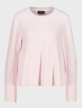 Light rose flared sweater with a relaxed fit, featuring long sleeves and a stylish, flowing silhouette.
