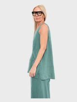 A close-up of a grass-green tank top, highlighting its sleeveless style and soft material.