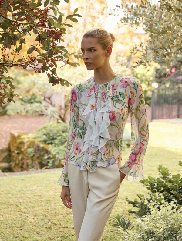 Ivory floral top featuring a delicate pattern, perfect for casual or semi-formal occasions.