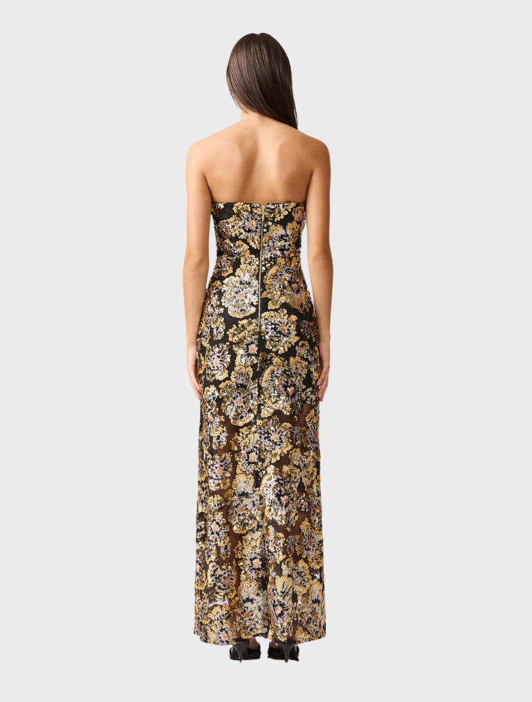 Elegant black and gold Celeste gown featuring a flowing silhouette and intricate detailing, perfect for formal occasions.
