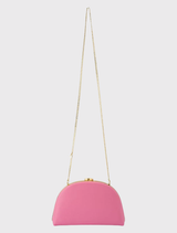 Pink Celeste Curved Clutch with a smooth leather finish, featuring a curved silhouette and optional chain handles for versatility.