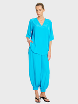 Cerulean Swish Plaza Top, showcasing a stylish cut and soft fabric, ideal for versatile wardrobe styling.