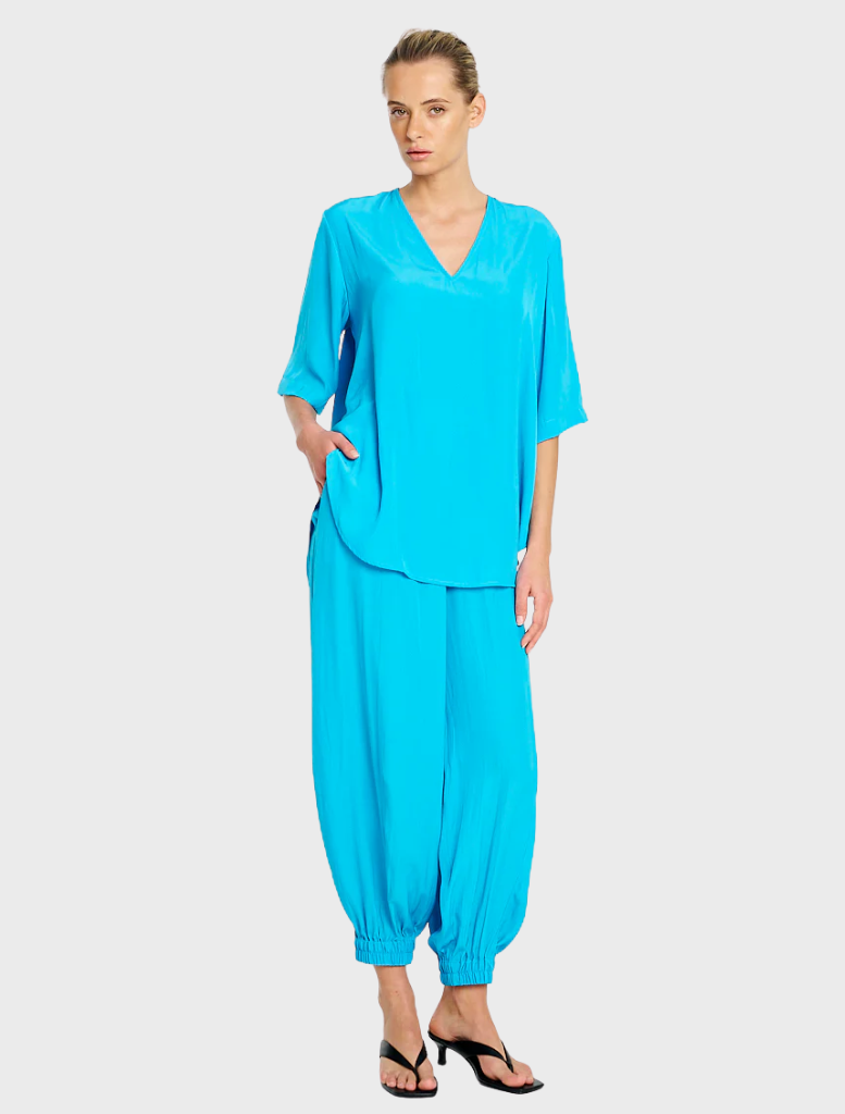 Cerulean Swish Plaza Top, showcasing a stylish cut and soft fabric, ideal for versatile wardrobe styling.