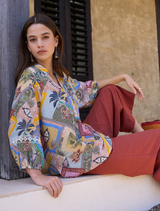 Floaty multi-colored blouse with V neckline, blouson sleeves, elasticated cuffs, and custom embroidery on placket and sleeves.