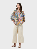 Multi-patterned blouse with a V neckline, elasticated blouson sleeves, and unique embroidery on the placket and lower sleeves.